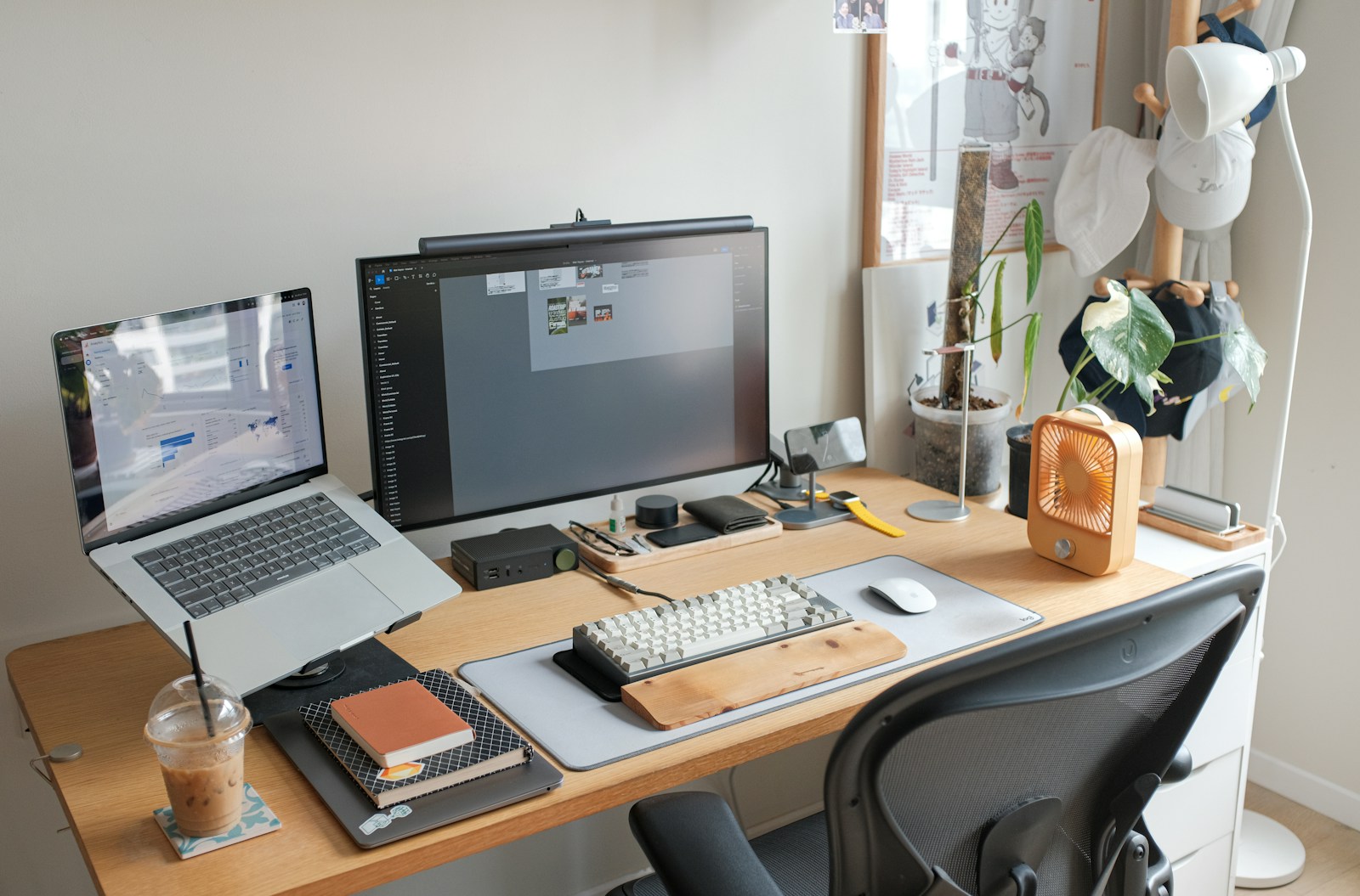 A workspace with a laptop and external monitor on a clean desk.